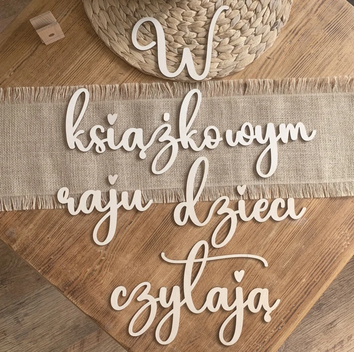 napis wycinany W książkowym raju dzieci czytają